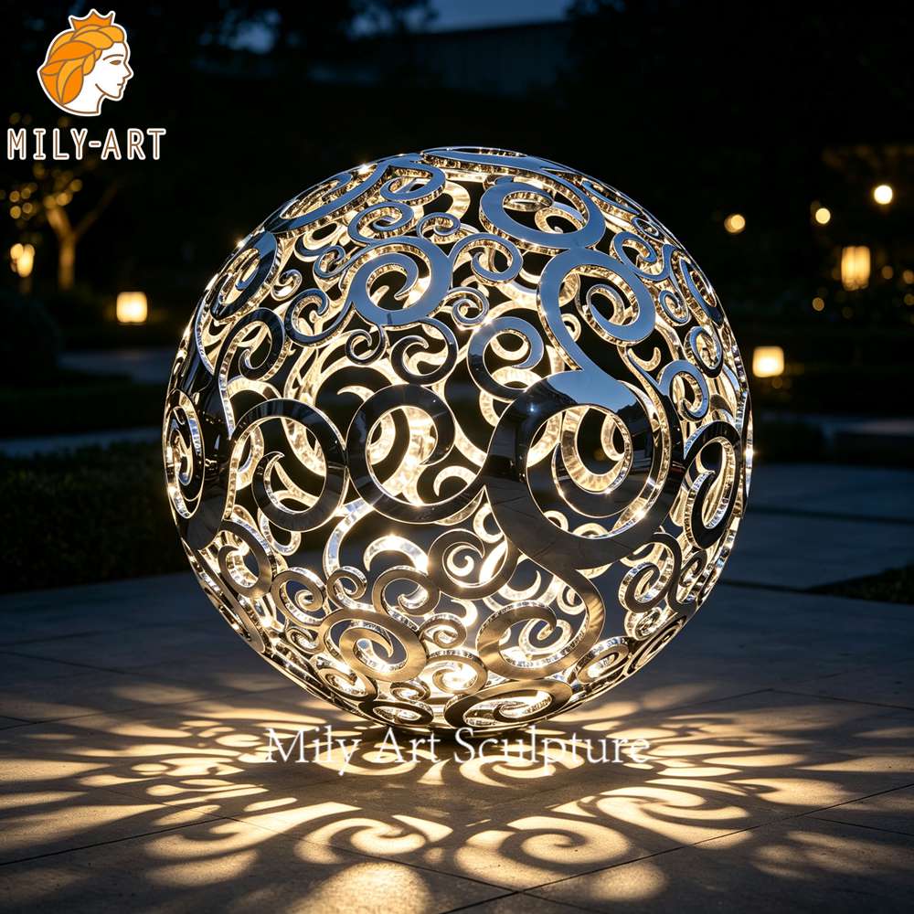 hollow metal sphere sculpture at night