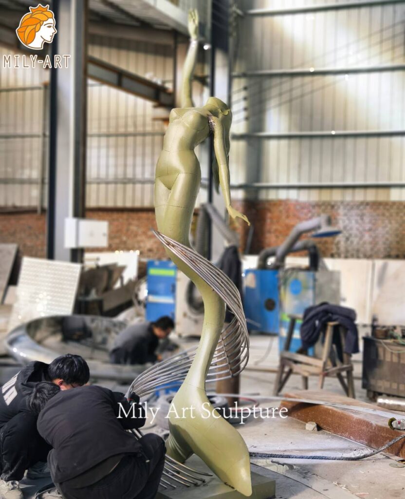 polished metal mermaid sculpture