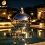 stainless steel sphere water feature night