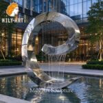 large metal curved water fountain
